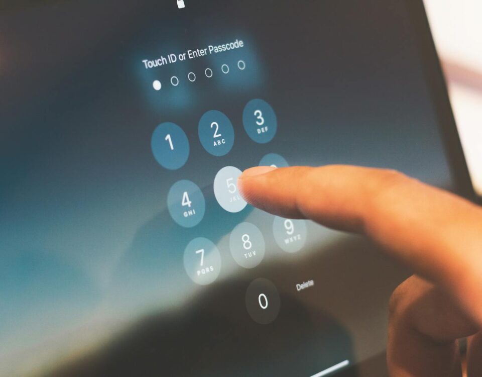 Close-up of a finger entering a passcode on a smartphone security screen.